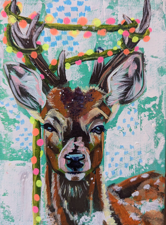 portrait painting of a young buck with Christmas lights draped around it's antlers on a teal and white background