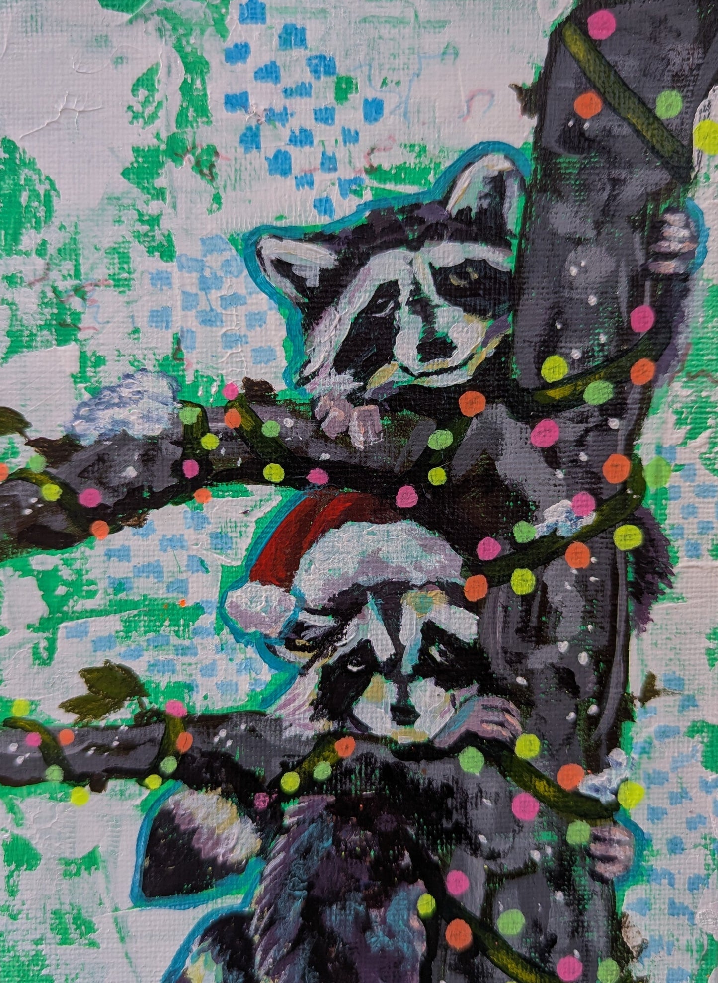 painting of two raccoons in a tree wrapped in vibrant Christmas lights. One raccoon is wearing a Santa hat. 